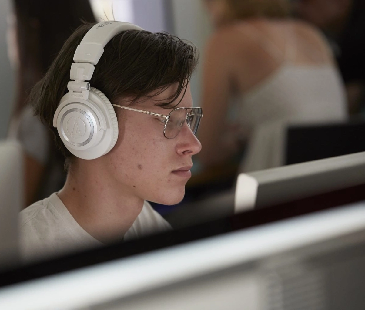 Close-up of someone working in headphones